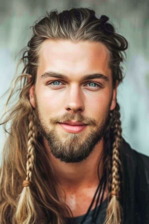 Hombre con pelo largo y trenzas tipo vikingo.